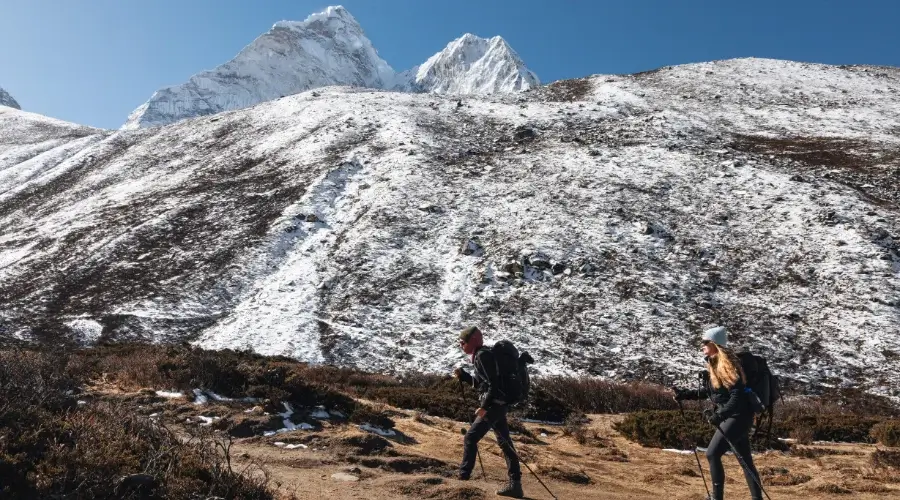 Trekkers walking past the mountains of Everest region