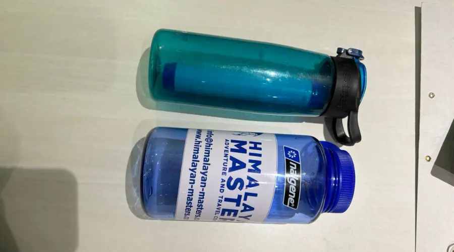 Water purification bottle on top and normal Himalayan Masters branded water bottle for the trek