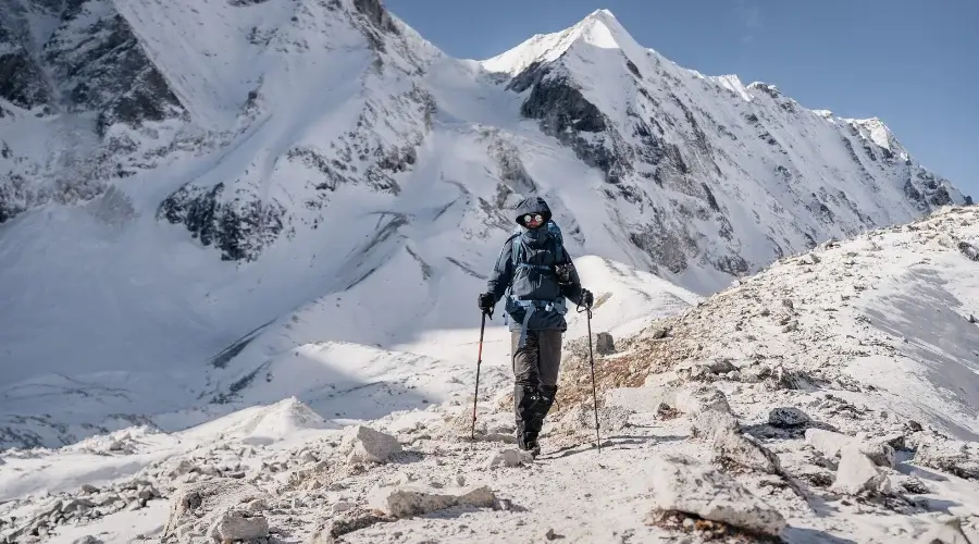 A climber ascending a mountain, gracefully making their way up the slope.