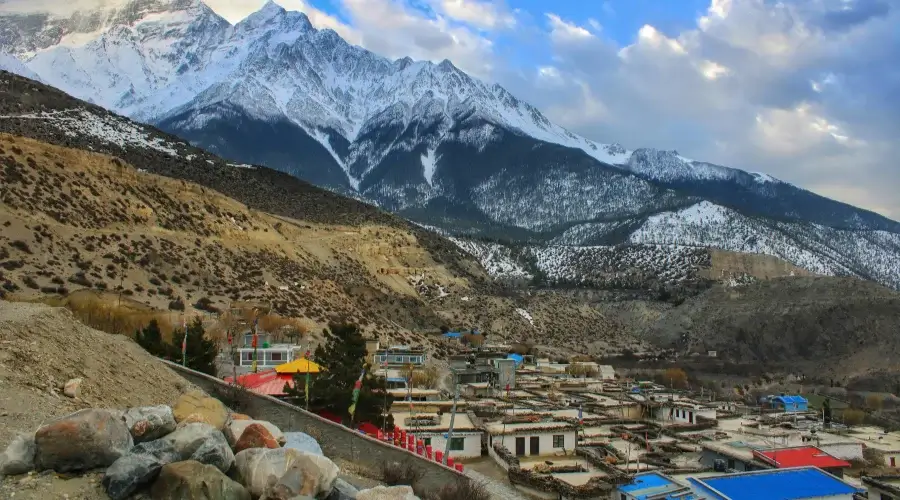 Beautiful village with majestic mountain in background