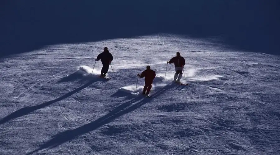 Skiers skiing down the slopes of a mountain