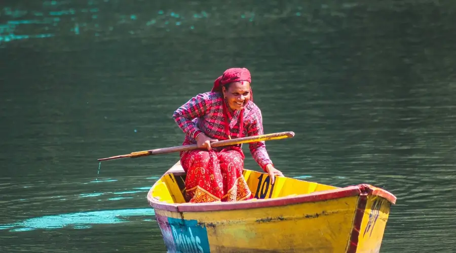 Nepali woman boating on a yellow boat