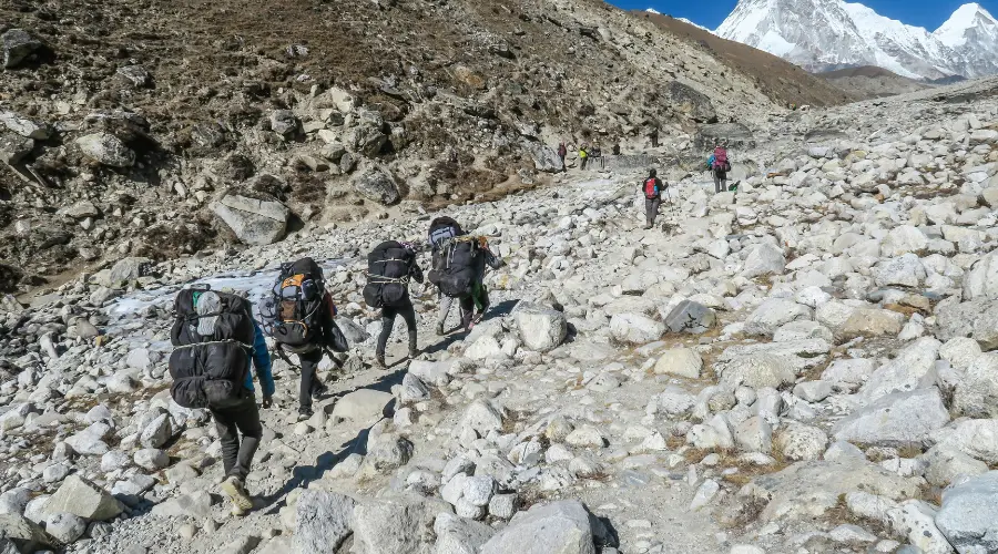 Trekkers and porters trekking in the Everest Khumbu region