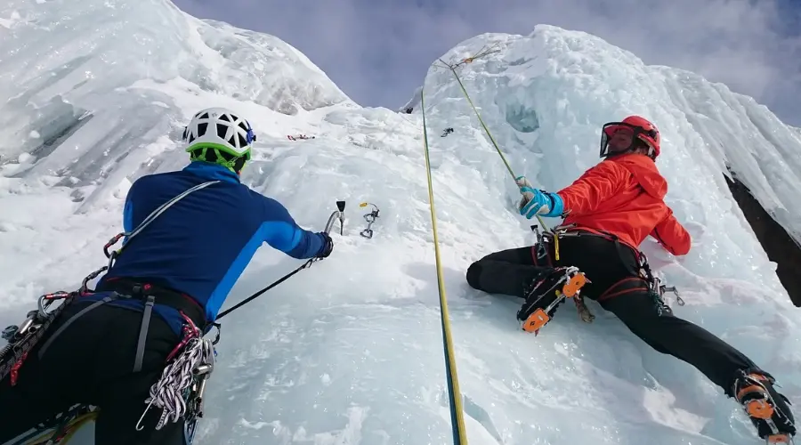 Two mountaineers climbing mountain