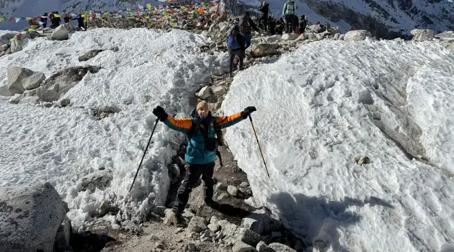 Trekker posing at Larkya La Pass, the highest point in Manaslu Circuit Trek