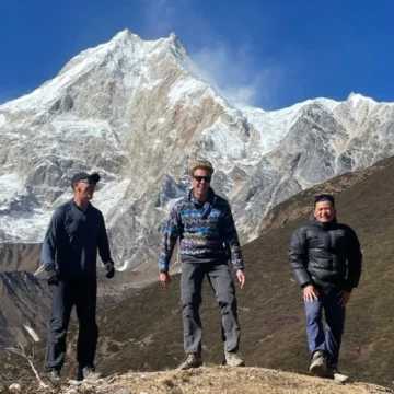 Trekking posing infront of majestic Mount Manaslu