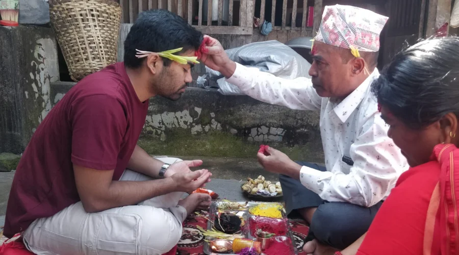 Son receiving blessings from his parents during the Dashain festival