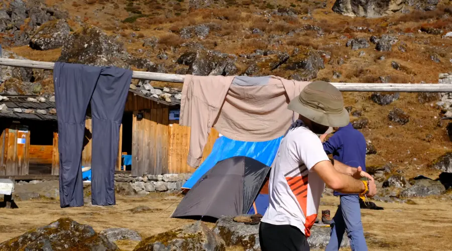 A trekker drying his/her clothes during the trek