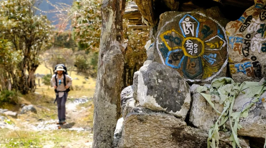 A Trekker Walking by Mani Wall
