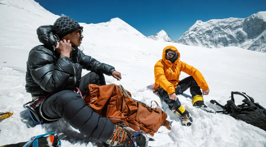 A mountaineer and a climbing guide resting during an expedition - A part of Mountaineering Training in Nepal