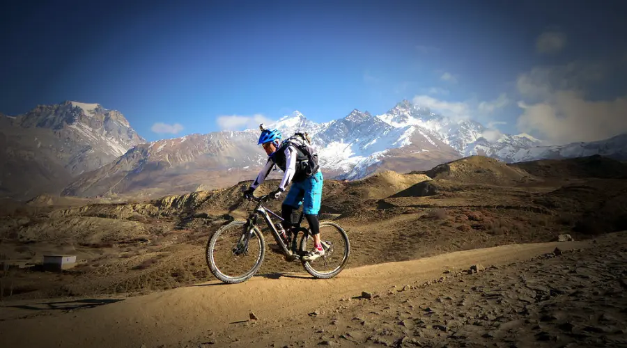 Mountain biker biking in the arid landscapes of Mustang