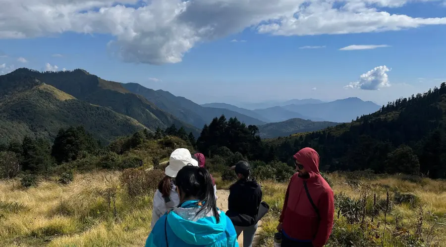 Trekkers on a yoga trek with a stunning mountain view